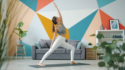 Woman practicing yoga in a modern living room.