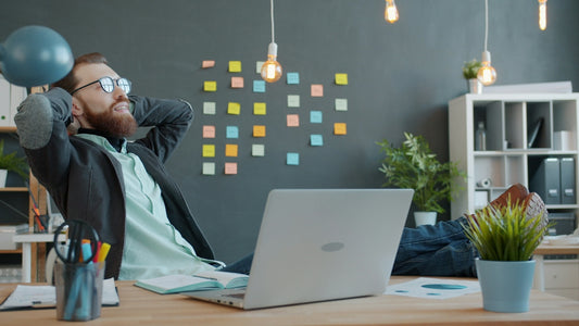 Man relaxing with feet on desk in office